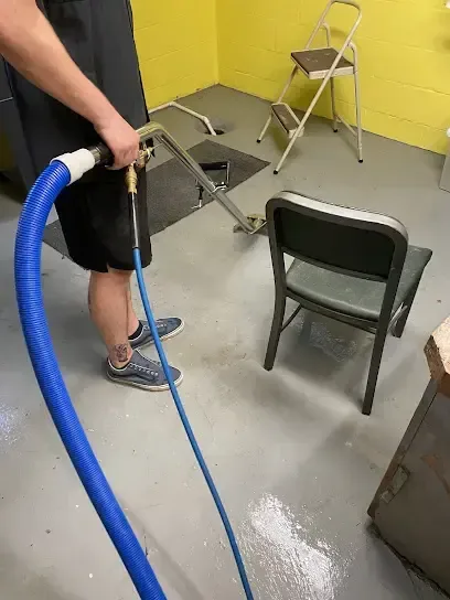 Extraction hose pulling standing water off a painted floor