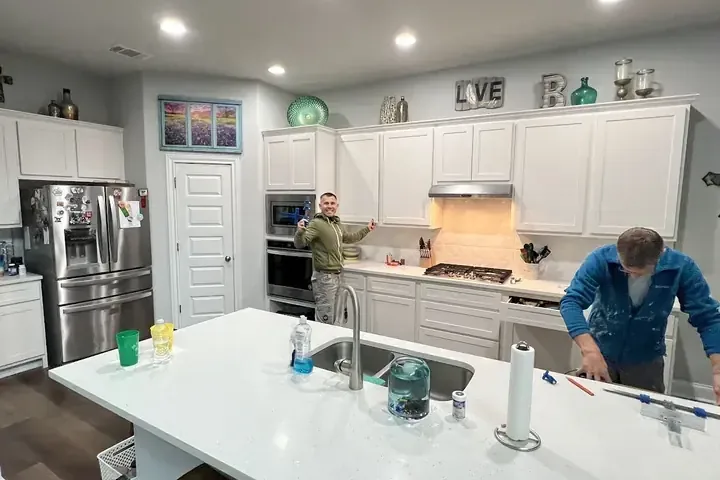 Crew working in a kitchen after a supply pipe leak