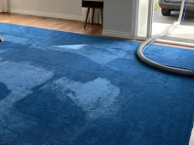 Air mover drying a closet floor and wall bottom after a water heater tank leaked
